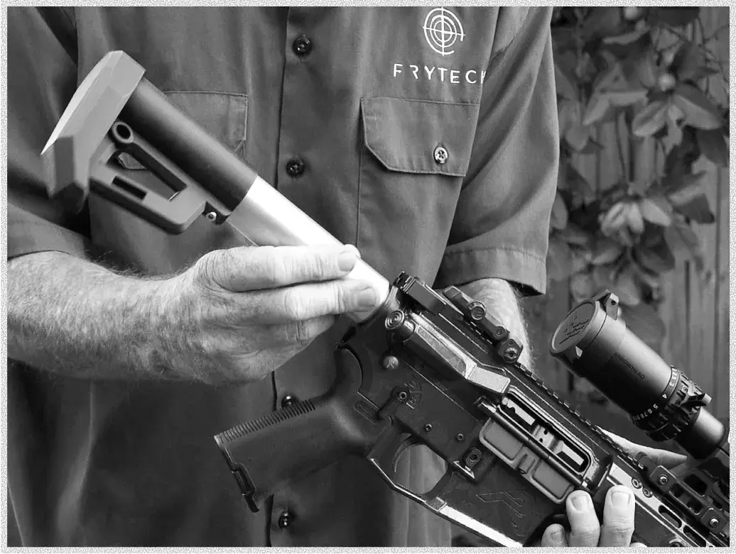 A person holds a sleek firearm with a mounted scope, showcasing a detachable stock, demonstrating firearm customization.